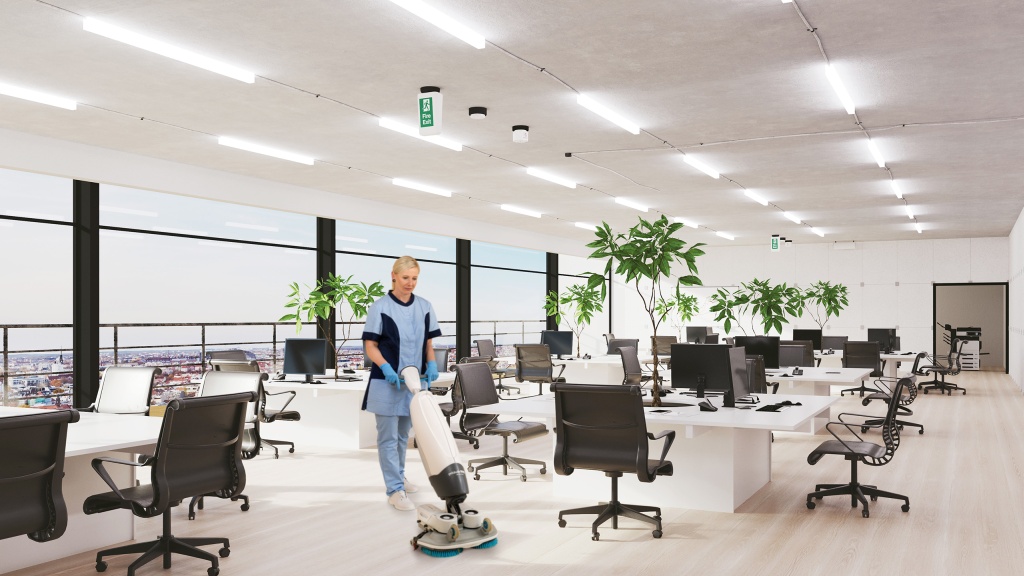 Mitarbeiterin von RWS Gebäudeservice reinigt mit einer Maschine den Boden in einem modernen Großraumbüro.